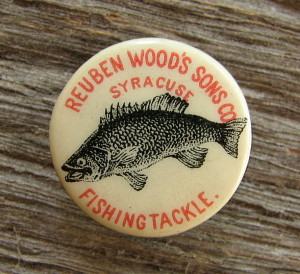 Reuben Woods Was A Highly Sought Fly Fishing Guide Throughout New York And Canada, Was An Accomplished Tournament Fly Caster And In 1863 Invented "Lollacapop" Mosquito Repellent. In 1883 Woods Oversaw The Light Fishing Tackle of America Exhibit At The International Fisheries Exhibition In London, England, Where He Won First Prize In The Trout And Salmon Fly Casting Competitions.  Woods Died In 1884.  ~~~~~~~~~~~~~~~~~~~ This Tiny  ( 7/8" ) Advertising Button Was Made By Whitehead & Hoag, Circa 1895. Interestingly Both Benjamin Whitehead & Chester Hoag Were Fond Of Fishing. Whitehead Reportedly Had A Collection Of 2,000 Rods And Reels. Sounds Like A Reasonable Number To Me !
